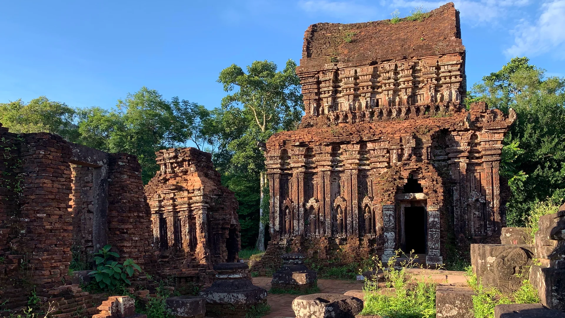 Ancient red-brick Cham temple towers among green hills at My Son